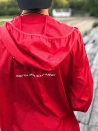 Rear view of man standing in red water