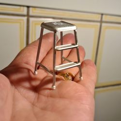 Close-up of hand holding ring against wall