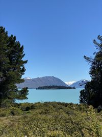 Scenic view of mountains against clear blue sky