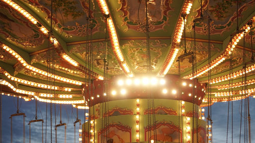 Low angle view of illuminated ferris wheel at night