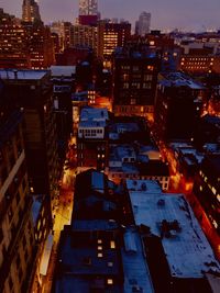 High angle view of illuminated buildings in city at night