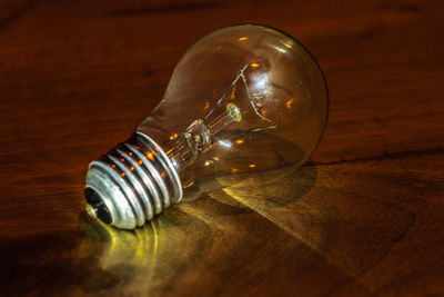 Close-up of light bulb on table