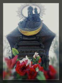 Low angle view of statue against temple