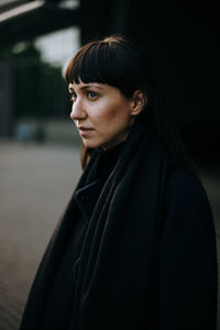 Thoughtful young woman standing on road