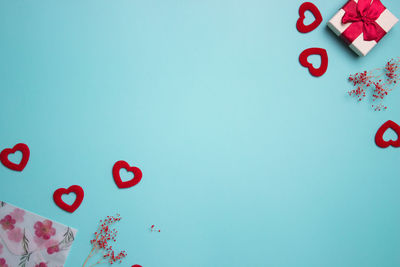 Directly above shot of heart shapes on blue background