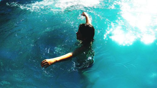 High angle view of boy swimming in pool