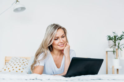 Smiling young woman using mobile phone