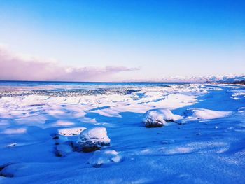 View of frozen sea against sky during winter