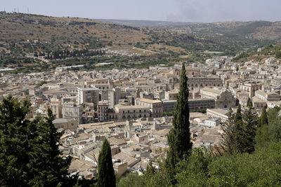 High angle view of townscape by mountain