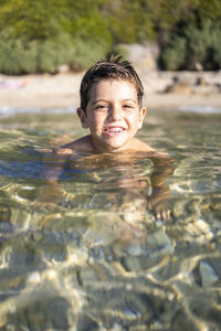 Portrait of boy swimming in pool