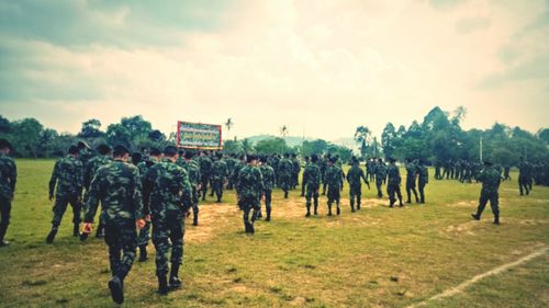 People on field against sky