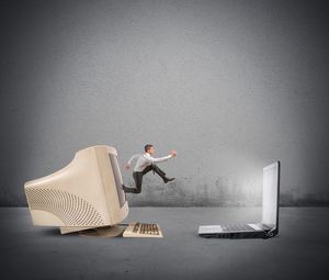 Side view of man sitting on chair against wall