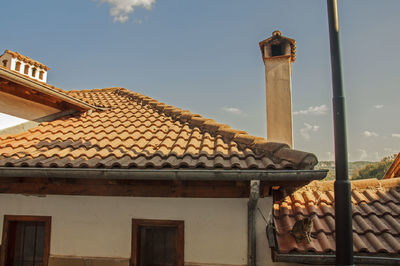 Low angle view of building roof against sky