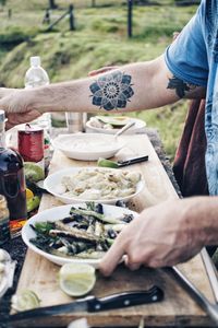 Midsection of man preparing food on table