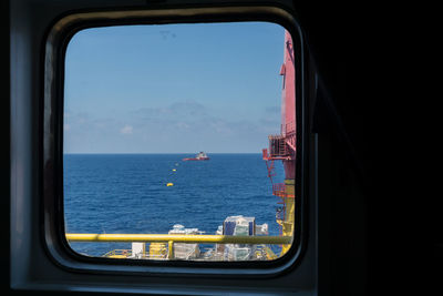 View of sea seen through window