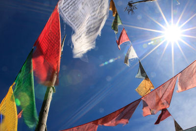 Low angle view of flags hanging against sky