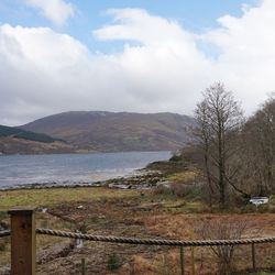 Scenic view of lake against cloudy sky