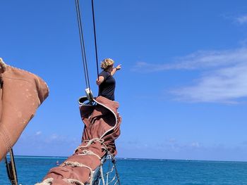 Man in sea against clear blue sky