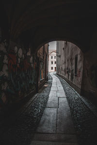 Empty alley amidst buildings in city