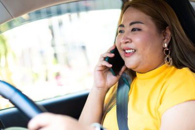 Portrait of smiling woman using mobile phone