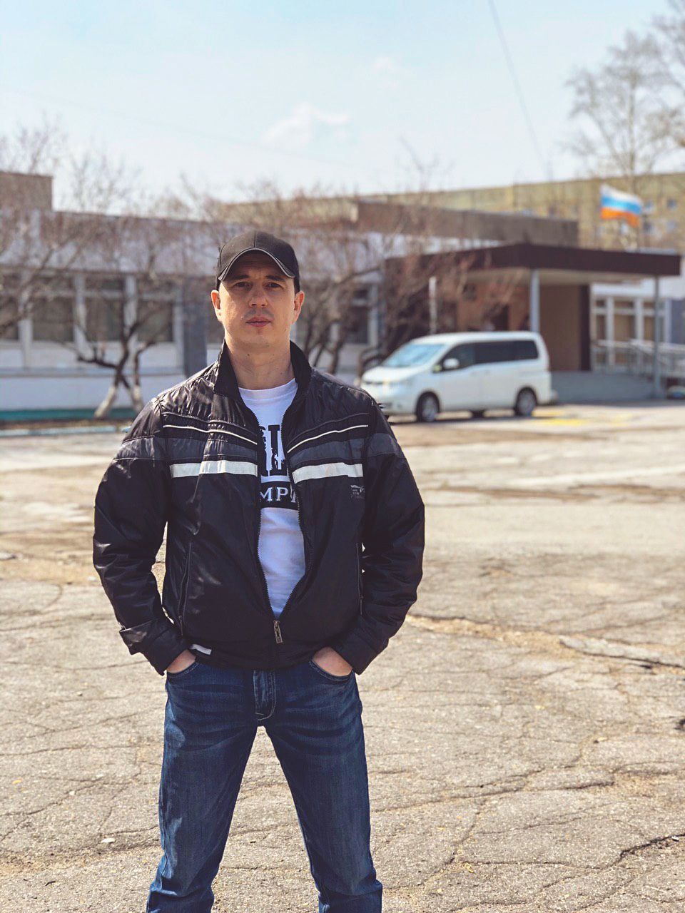 one person, standing, young men, real people, young adult, front view, lifestyles, leisure activity, casual clothing, built structure, day, hands in pockets, architecture, car, nature, focus on foreground, building exterior, transportation, clothing, outdoors, teenager, adolescence, teenage boys