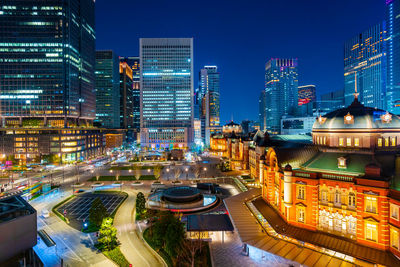 Aerial view of illuminated buildings in city at night