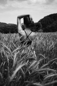 Woman standing on field against sky