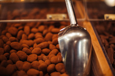 Serving scoop on food in container at store