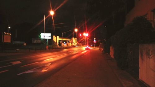 Illuminated city street at night