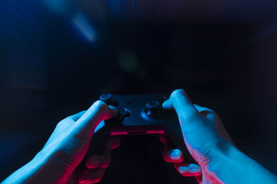 Close-up of hand holding cigarette against blurred background