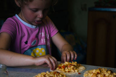 Midsection of girl holding ice cream at home