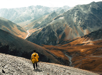 Rear view of man hiking on mountain