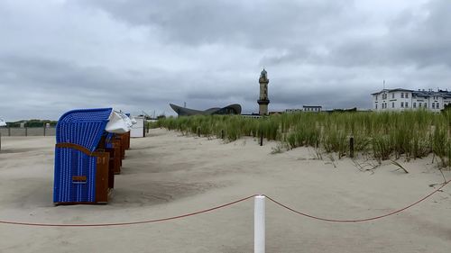 Wooden posts on beach against sky