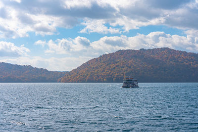 Lake towada sightseeing cruises in autumn season. towada hachimantai national park, aomori, japan.