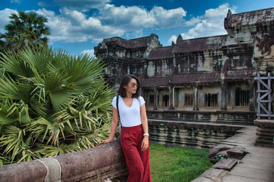 Thai girl is exploring the ancient ruins of angkor wat hindu temple complex in siem reap, cambodia
