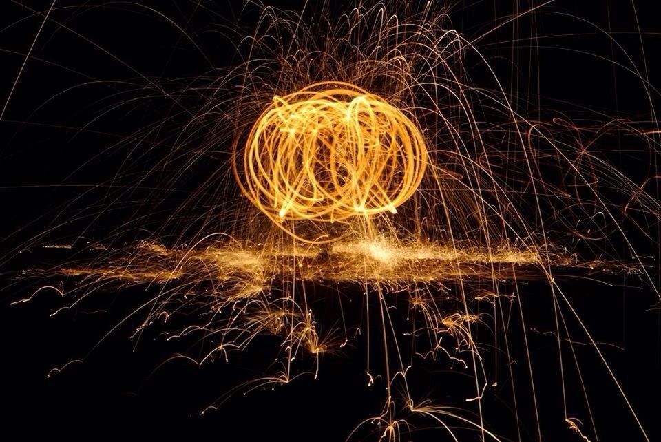 night, illuminated, long exposure, motion, glowing, arts culture and entertainment, sparks, blurred motion, low angle view, celebration, circle, spinning, firework display, exploding, dark, light painting, light trail, light, event, sky