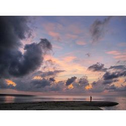 Scenic view of sea against cloudy sky