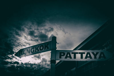 Low angle view of road sign against sky