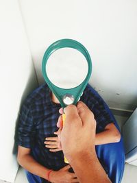 Midsection of a man holding glass