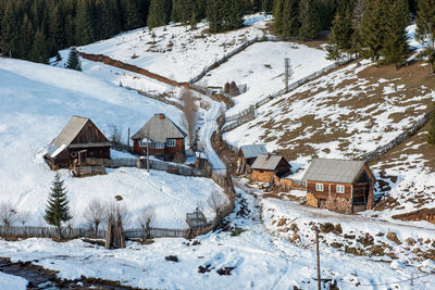 Houses on snow covered field