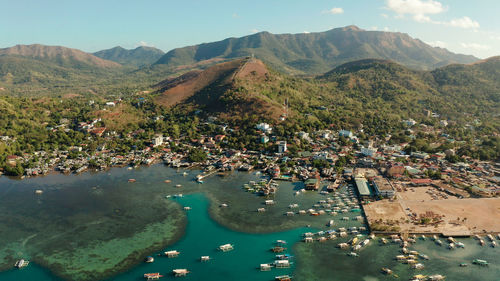 Coron city with slums and poor district. sea port, pier, cityscape coron town with boats on busuanga