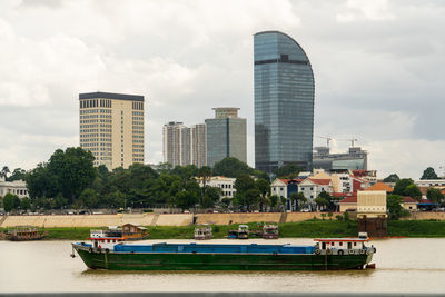 View of high rise building in phnom penh city with mekong river view and boat.