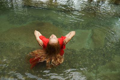 High angle view of woman swimming in lake