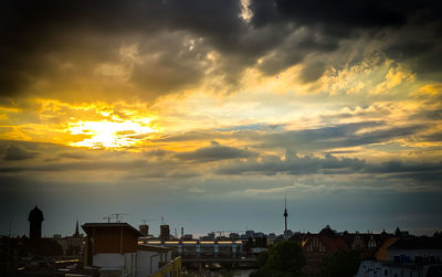 Silhouette buildings against sky during sunset