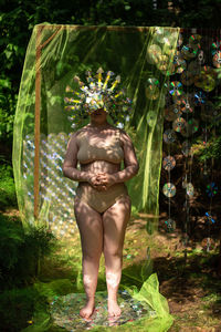 Rear view of women in bikini standing in park