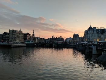View of river in city at sunset