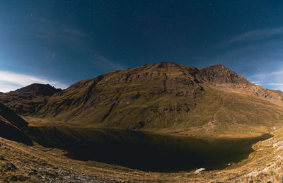 Scenic view of mountains against sky at night