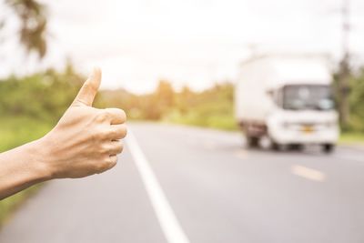 Midsection of man skateboarding on road