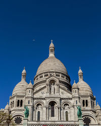 Low angle view of building against blue sky