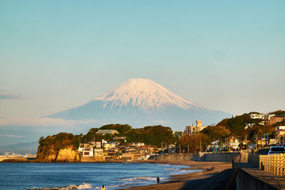 Scenic view of sea and mountains against sky